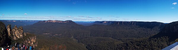 View of Jamison Valley from north escarpment, outside Katoomba: Three Sisters far left; Mount Solitary left of centre; Narrowneck Plateau, far right, all part of the Blue Mountains region BlueMountains123.jpg