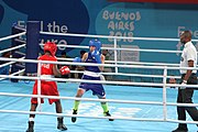 Deutsch: Boxen bei den Olympischen Jugendspielen 2018 Tag 12, 18. Oktober 2018 - Finale Fliegengewicht Mädchen – Martina La Piana (Italien, blau) schlägt Adijat Gbadamosi (Nigeria, rot) 5-0; Ringrichter ist James Beckles (Trinidad und Tobago). English: Boxing at the 2018 Summer Youth Olympics on 18 October 2018 – Girl's flyweight Gold Medal Bout - Martina La Piana (Italy, blue) beats Adijat Gbadamosi (Nigeria, red) 5-0; Referee is James Beckles (Trinidad and Tobago). Español: Boxeo en los Juegos Olímpicos Juveniles de Verano de 2018 en 18 de octubre de 2018 - Combate a medalla de oro de peso mosca para mujeres: Martina La Piana (Italia, azul) le gana a Adijat Gbadamosi (Nigeria, roja) 5-0; El árbitro es James Beckles (Trinidad y Tobago).