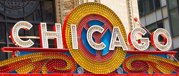 The Y-shaped figure behind the horizontal word Chicago on the State Street marquee is the city's "municipal device," a badge which symbolizes the fork