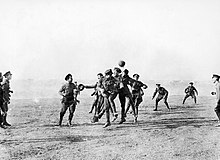 B&W photo of British soldiers playing football