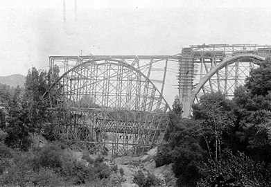 1913 view looking north at the Colorado Street Bridge over the Arroyo, under construction and the Scoville Bridge behind.