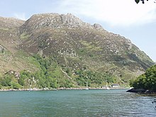 Tarbet Bay Crags on Cnoc a Bhac Fhalaichte tower over Tarbet Bay - geograph.org.uk - 190060.jpg