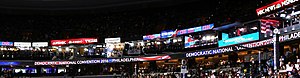 The originally-planned full-scale convention in Fiserv Forum would have seen broadcasters set up live sets inside the arena, similar to those in this image of the 2016 Democratic National Convention. DNC A1205ED6 (1).jpg