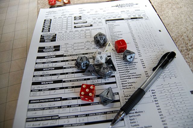 Players utilize both dice and character sheets during a game session.