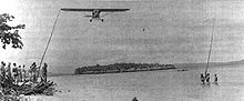 A Piper Cub of the 1st Marine Division's improvised air force snags a message from a patrol on New Britain's north coast.