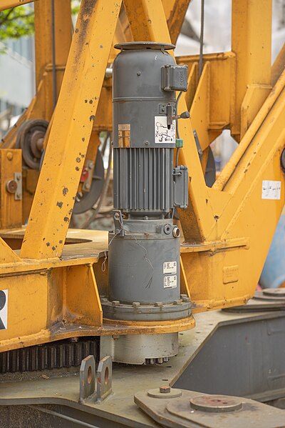 File:Electric motor on the slewing bearing of a remote controlled yellow Liebherr tower crane.jpg