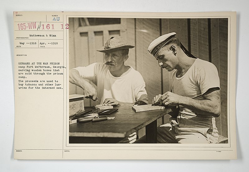 File:Enemy Activities - Internment Camps - Fort McPherson, Georgia - Germans at the war prison camp Fort McPherson, Georgia, carving wooden boxes that are sold through the prison camp. The proceeds are used to buy tob(...) - NARA - 31479077.jpg