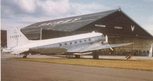 Fairey Air Surveys Douglas DC-3 outside Fairey's 1937-built hangar at Manchester Airport during servicing in 1975