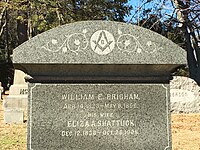 A late 19th century headstone adorned with the Masonic square and compass