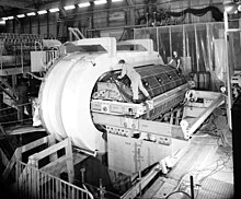 Installation of the Gargamelle chamber body. Placement of the chamber in the oblong shaped magnet coils. Gargamelle bubble chamber, CERN 1970.jpg