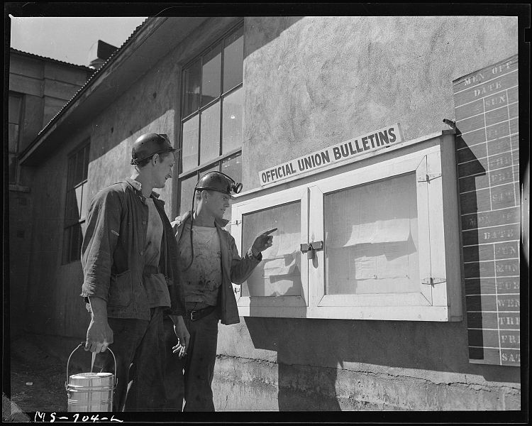 File:J. M. Hawkins (left) former pharmacists mate in the U.S. Navy and Wm. Smith, former Marine, read notice on the... - NARA - 540561.jpg