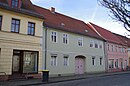 Residential house with side wing and outbuildings as well as courtyard paving and garden