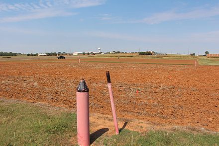 Boundaries of Plots indicated by pink posts. Note unfertilized "check" area in center of photo denoted by lack of stubble Magruder Plot 3.jpg