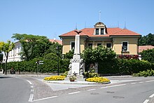 Il Monumento ai Caduti di Uggiate. Dietro Villa Lavizzari, in fondo a sinistra le scuole elementari.