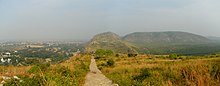 View of the Rajgir Hills, an inspiration for the fictional Marabar Hills. Rajgir 12 hills panorama (31396985691).jpg