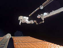 Astronaut Scott Parazynski at the end of the Orbiter Boom Sensor System performing the solar array repair. STS120EVA4.jpg