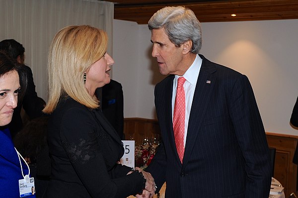 Huffington speaks with U.S. Secretary of State John Kerry during a dinner hosted by Coca-Cola CEO Muhtar Kent on the sidelines of the World Economic F