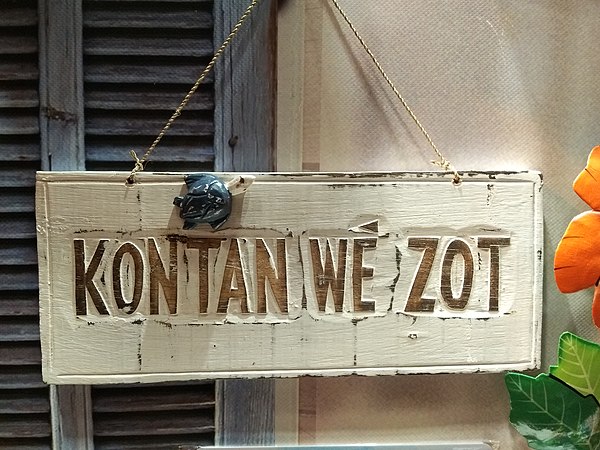 Welcome sign in Martinican Creole: Kontan wè zot, "Happy to see you" (from the French words content, voir, vous-autres).