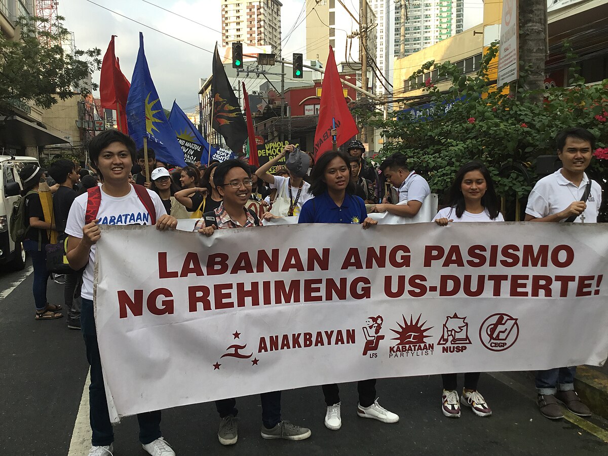 A protester holds up a poster of Philippine President Joseph