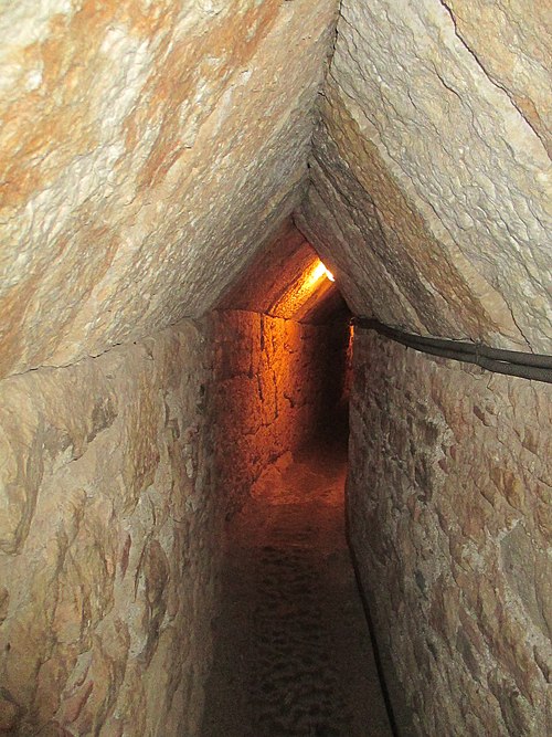 Reinforced section of the tunnel, with pointed roof and polygonal masonry walls.