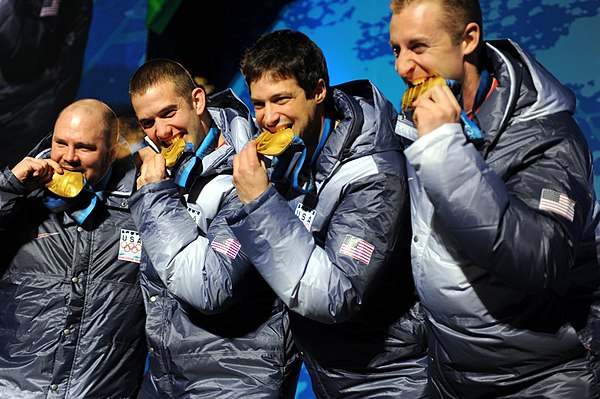 The crew of the four-man USA-1 at the 2010 Winter Olympics with their gold medals. From left to right: Holcomb, Justin Olsen, Steve Mesler, and Curtis