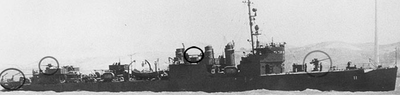 Converted USS Hovey (DMS11) at Mare Island, May 1943, with three smokestacks. Shown circled from left to right are squared stern with cranes or davits to haul minesweeping gear, and guns visible aft, midship and forward AA gun USN Converted Circled Hovey May 1943.png