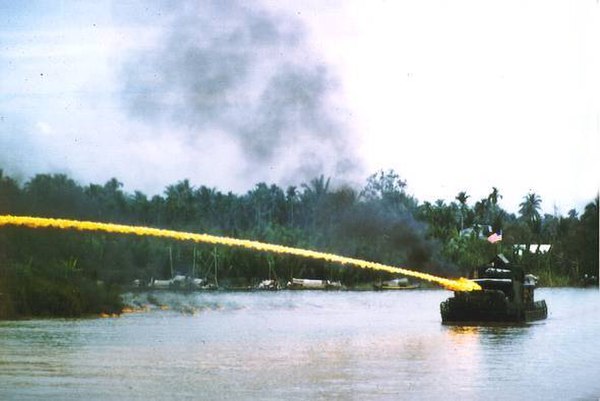 A United States Navy Monitor, a brown-water navy vessel, firing napalm during the Vietnam War