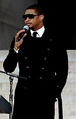 Usher performing at the We Are One: The Obama Inaugural Celebration at the Lincoln Memorial in 2009 Usher Looking To Obama.jpg