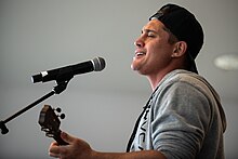 Makua Rothman performing on a USO tour at Ramstein Air Base in 2019 VCJCS 2019 USO Tour 190330-D-SW162-1439-2 (32560929287).jpg