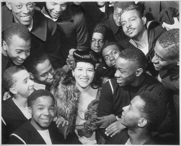 File:"Surrounded by recruits, Marva Louis, wife of champion Joe (Louis), takes time out from a tour of nightclubs to... - NARA - 535855.tif