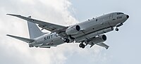 A Boeing P-8 Poseidon, tail number 168996, on final approach at Kadena Air Base in Okinawa, Japan. It has an AN/APS-154 Advanced Airborne Sensor (AAS) mounted underneath it.