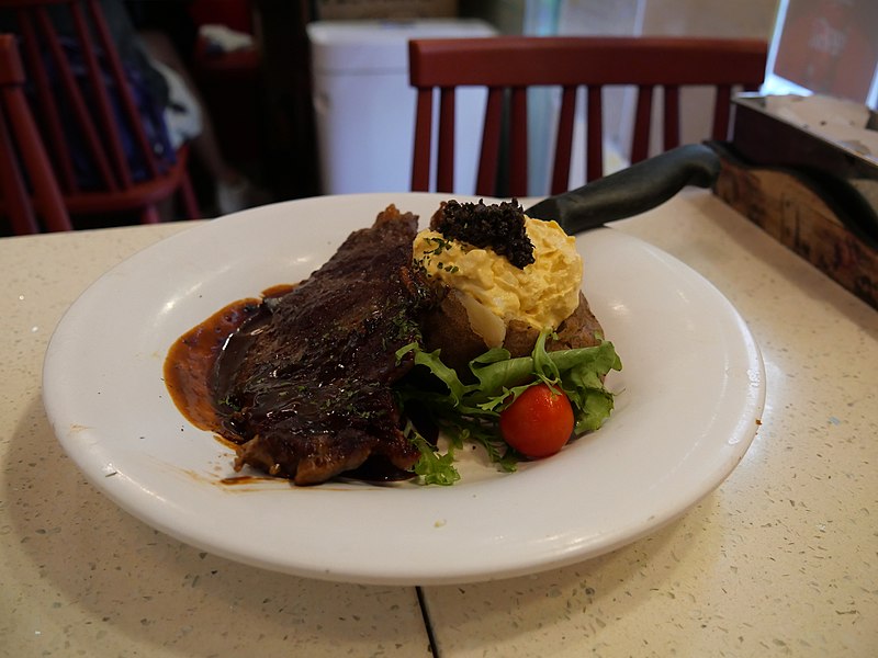 File:A New Zealand Beef steak with baked potato with egg sauce and tuffle sauce and knife.jpg