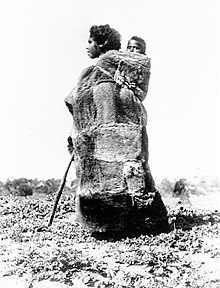 Aboriginal woman in a kangaroo skin cloak carrying a child, c. 1860 Aboriginal woman in a kangaroo skin cloak carrying a child, South Australia, ca. 1860.jpg