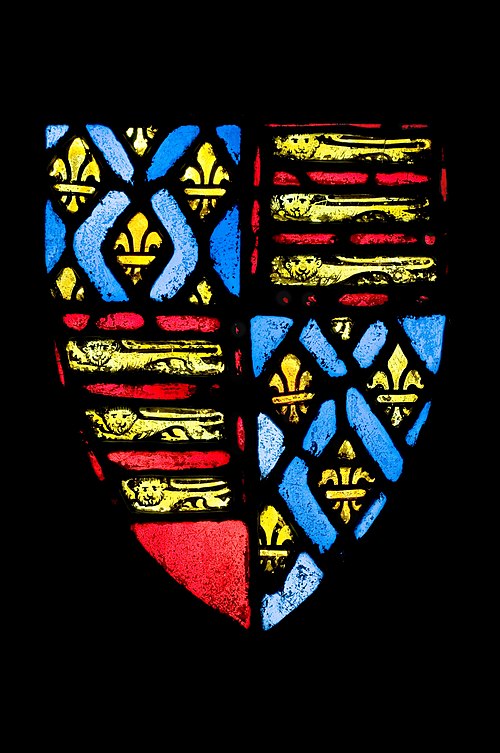 English stained glass window from c. 1350–77, showing the coat of arms of Edward III, which featured the royal arms of France in the positions of grea