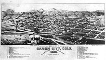 Bird's eye view of dwellings, commercial and civic buildings between the Arkansas River and mountains in This drawing of Canon City, Colorado, 1882.