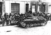 Black and white photo of soldiers with a small tank
