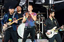 British rock band Coldplay co-wrote the song and performed its instrumentals. ColdplayManch03062351 (cropped).jpg