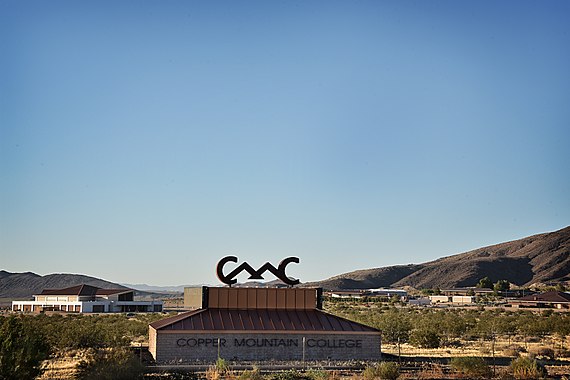Copper Mountain College sign with campus in background in June 2017