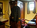 Officer quarters onboard the ship. Uniform of Master mariner is visible.