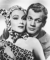 del Río dressed in a cheetah costume and being hugged by actor Joseph Cotten.