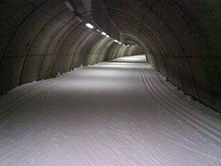 Indoor skiing climate controlled environment in which snow is manufactured using a snow cannon