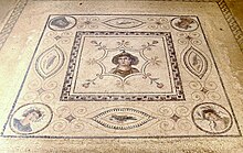 A 2nd-century CE Tunisian mosaic of Goddess Africa with Four Seasons. Goddess Africa with Four Seasons at the corner, a mosaic in El Djem Museum Tunisia.jpg