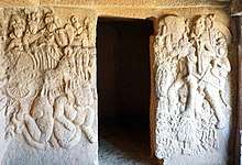Sculptures of Bodhisattva's guarding the entrance of the 1st century BCE Buddhist Cave 19 at Bhaja Caves. Guardians Surya and Indra at the Bhaja Caves.jpg