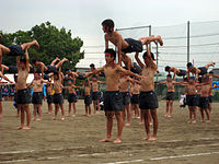 Gymnastics performed by shirtless boys in Japanese junior high school