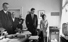 Kennedy, his wife Jacqueline, Johnson, and others watching the flight of Astronaut Shepard on television on May Fifth of 1961. Kennedy, Johnson, and others watching flight of Astronaut Shepard on television, 05 May 1961.png