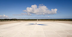 A person standing in the middle of the main landing pad demonstrates its size