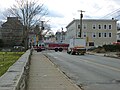 An fire truck from Lawrence Fire Department driving east on Branch Street. Taken at the intersection of Branch Street and School Street, Lowell, Massachusetts.