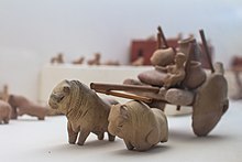 Clay and wood model of a bull cart carrying farm produce in large pots, Mohenjo-daro. The site was abandoned in the 19th century BC. Old bull cart.jpg