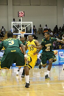 Marquette's Derrick Wilson drives against Norfolk State's Jamel Fuentes while Rashid Gaston trails at the 2011 Paradise Jam Tournament PJ Derrick Wilson and Jamel Fuentes.jpg