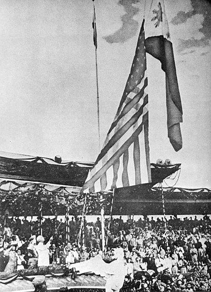 The Flag of the United States is lowered while the Flag of the Philippines is being raised during independence ceremonies, July 4, 1946.